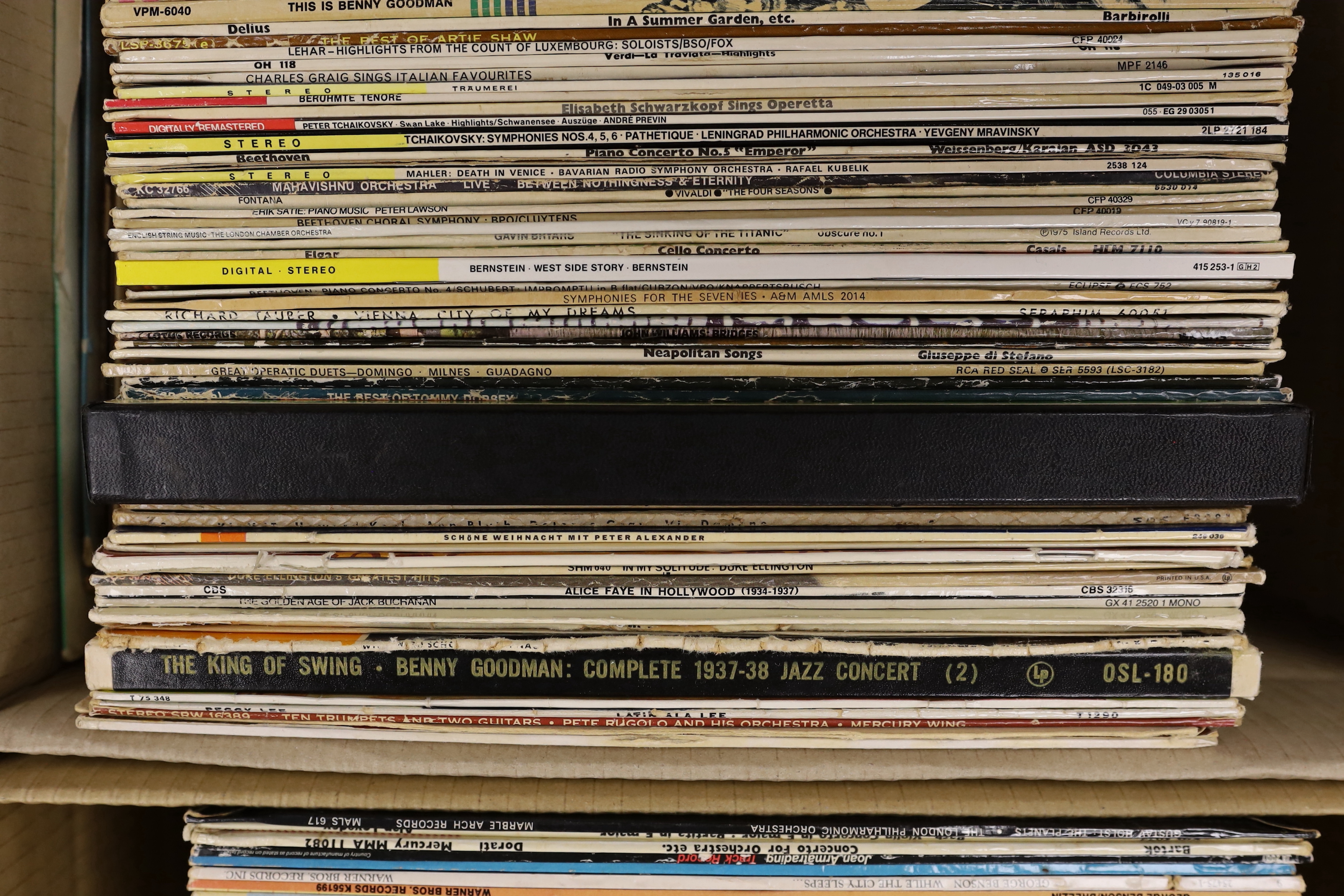 A collection of jazz and classical LPs, including Charlie Parker, Louis Armstrong, Glenn Miller, Perry Como, Artie Shaw, André Previn, Leonard Bernstein, Duke Ellington, Benny Goodman, plus some recordings of operas and